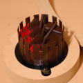The image is of a round chocolate cake on a wooden base. The cake is covered in a thick layer of dark chocolate and has a dar...
