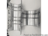 The image shows a pair of stainless steel cuff bracelets. The bracelets are cylindrical in shape and have a shiny, metallic f...