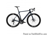 The image is of a blue-colored road bike with the brand name "DT Swiss" written on the frame. The bike has a sleek and modern...