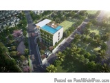 The image is an aerial view of a modern apartment complex. The complex is surrounded by lush greenery and trees, and there is...