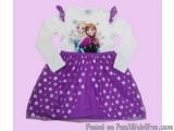 The image is of a children's dress for girls. The dress is white with a purple skirt that has a star pattern. The skirt is ma...