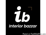 The image is a logo for an interior bazaar. It is a black square with a white text in the center that reads "Interior bazaar"...