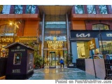 The image shows the entrance of a hotel named "The Orion Express". The hotel is located in a modern building with a glass fac...