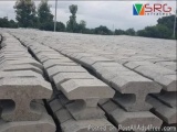 The image shows a large pile of concrete blocks arranged in a grid-like pattern. The blocks are of different sizes and shapes...
