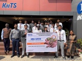 The image shows a group of young people standing in front of a building with a sign that reads "KITS NSS Week". The group is...