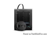 The image shows a black 3D printer with a black handle on top. The printer is standing upright and has a sleek, modern design...