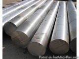 The image shows a group of six cylindrical metal rods stacked on top of each other. The rods appear to be made of steel or al...