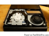 The image shows the inside of a black computer case with a fan and heatsink inside. The case appears to be open, revealing th...