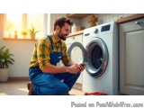 In this image, we can see a young man in a kitchen, kneeling on the floor in front of a washing machine. He is wearing a yell...