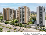 The image shows an aerial view of a residential complex. There are three tall buildings in the image, each with a unique desi...