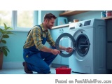 In this image, we can see a young man in a kitchen, kneeling on the floor and fixing a washing machine. He is wearing a yello...