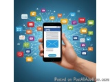 The image shows a hand holding a black smartphone with the SMS app open on the screen. The background is a solid blue color a...