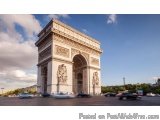 The image is a photograph of the Arc de Triomphe in Paris, France. The arch is a large, ornate structure with a white façade...