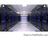 The image shows a long corridor in a data center. The corridor is lined with rows of servers, each with a blue light shining...