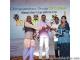 The image shows a group of four people standing on a stage with a banner that reads "Chitravansham Group of College (Knowledg...