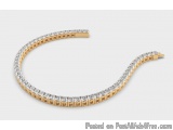 The image is of a gold bracelet with a curved design. The bracelet is made up of small, rectangular diamonds arranged in a zi...