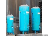 The image shows three large blue tanks or tanks in a warehouse or industrial setting. The tanks are cylindrical in shape and...