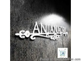 The image is a black and white photograph of the word "ANJANADRI" written in a cursive font. The word is written in white cap...