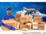 The image shows a man wearing a blue uniform and a cap, standing in front of a pile of cardboard boxes with the words "Franch...