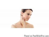 The image is a close-up portrait of a young woman with her hand on her neck. She is facing the camera and her head is tilted...