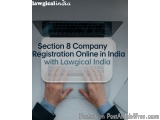 The image shows a laptop with a pair of hands typing on the keyboard. The laptop is placed on a desk with a white background....