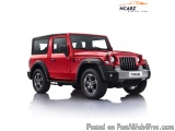 The image is of a red Jeep Wrangler JK, a four-door SUV with a rugged and off-road design. It has a black roof rack and black...