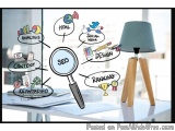 The image is a visual representation of SEO (Search Engine Optimization) and its related concepts. It shows a desk with a lam...