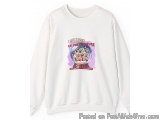 The image is of a white sweatshirt with a graphic design on the front. The design features a colorful illustration of a snow...