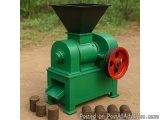 The image shows a green-colored wood pellet making machine. It has a large hopper at the top, which is used to feed the pelle...