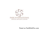 The image is a logo for Park International Dental Implants Center. It is a simple design with a white background and a brown...