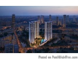 The image is an aerial view of a city at dusk. The city is densely populated with tall buildings and skyscrapers. In the cent...