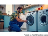 In this image, we can see a man in a kitchen, kneeling on the floor and fixing a washing machine. He is wearing a yellow and...