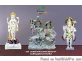 The image shows three Hindu deities, Lord Hanuman, Lakshmi, Radha, and Krishna, made of marble. They are arranged in a triang...