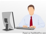 The image shows a man sitting at a desk in front of a computer monitor. He is wearing a white shirt and a red tie. The man is...