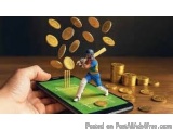 The image shows a hand holding a smartphone with a miniature figurine of a cricket player on the screen. The figurine is wear...