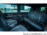 The image shows the interior of a car, specifically the back seats. The seats are black leather and appear to be in good cond...