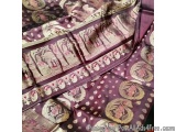 The image shows a close-up of a piece of fabric with a purple and gold color scheme. The fabric appears to be made of silk or...