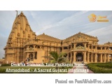 The image shows a beautiful Hindu temple in Ahmedabad, India. The temple is made of stone and has intricate carvings and desi...