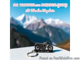 The image shows a keychain with a model of a motorcycle on it. The motorcycle is black and silver in color and has a sleek de...