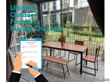 The image shows a patio with a wooden table and four chairs. The table is rectangular in shape and has a vase of flowers on i...
