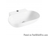 The image is of a white oval-shaped bathroom sink. The sink is made of ceramic and has a smooth, glossy finish. It has a sing...