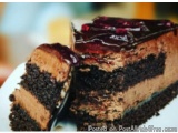 The image is of a slice of chocolate cake on a white plate. The cake appears to be moist and has a rich, dark chocolate color...