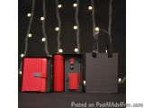 The image shows three items arranged on a black surface with a string of lights in the background. On the left, there is a re...