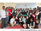 The image shows a group of people posing for a group photo in front of a banner that reads "Kannada Group of Companies". The...