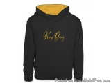 The image is of a black hoodie with a yellow hood. The hoodie has a drawstring hood and a kangaroo pocket. On the front of th...