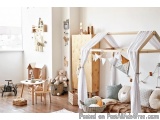 The image shows a child's room with a wooden playhouse in the center. The playhouse has a white canopy with white curtains ha...