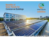 The image shows a large building with multiple solar panels on its roof. The building appears to be a commercial building wit...