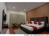 The image shows a modern and luxurious bedroom with a large bed in the center. The bed has a brown leather headboard and is n...
