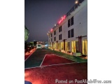 The image shows a large white building with a red neon sign that reads "Banquet" on the side. The building appears to be a ho...