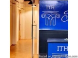 The image shows a hallway with a blue sign on the right side. The sign has the letters "ITH" written in white capital letters...